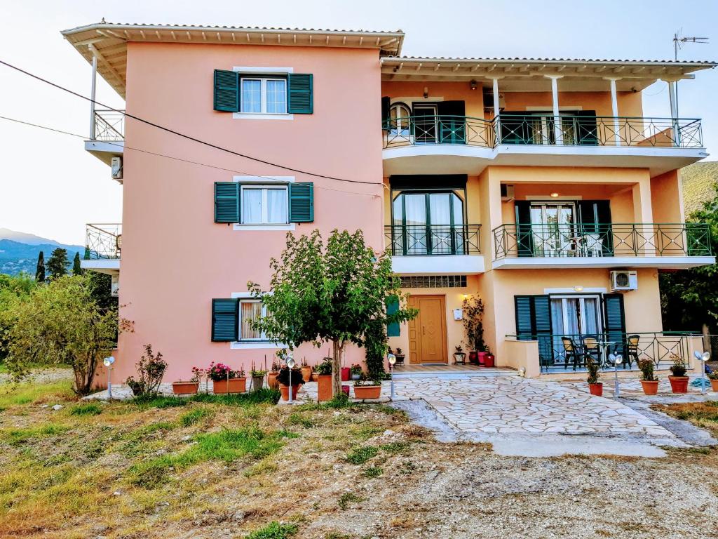 a pink house on a hill at STUDIOS LEFTERIS in Nydri