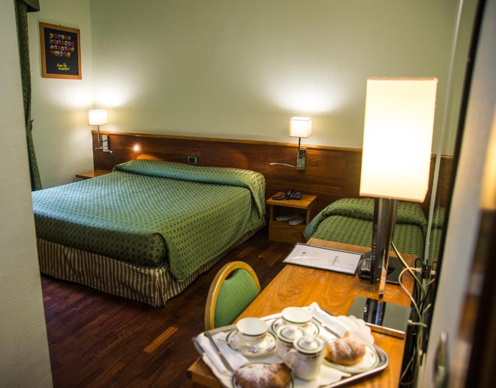 Postel nebo postele na pokoji v ubytování Hotel Giubileo