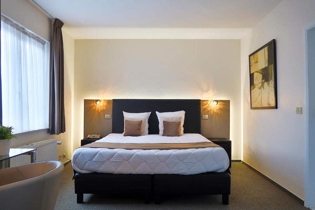 Postel nebo postele na pokoji v ubytování Hotel Adoma