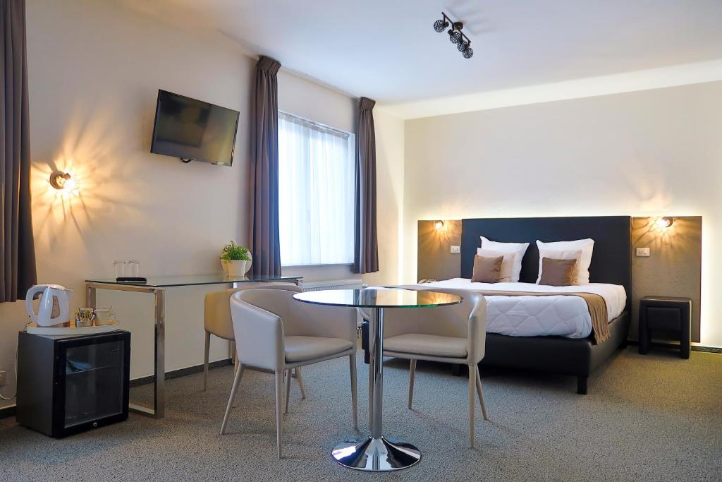 Postel nebo postele na pokoji v ubytování Hotel Adoma