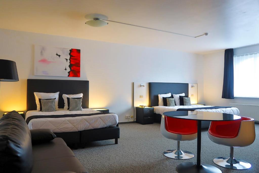 Postel nebo postele na pokoji v ubytování Hotel Adoma