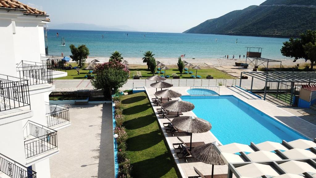 a view of a swimming pool with umbrellas and a beach at Surf Hotel in Vasiliki