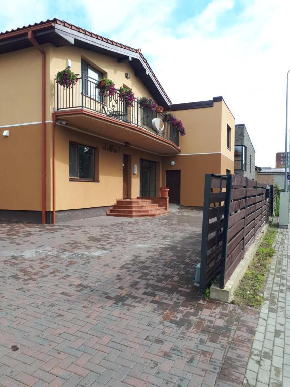 a brick building with a wooden floor and brick walls at Juro Guest House in Šiauliai