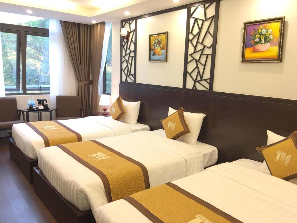 Postel nebo postele na pokoji v ubytování T&M Luxury Hotel Hanoi