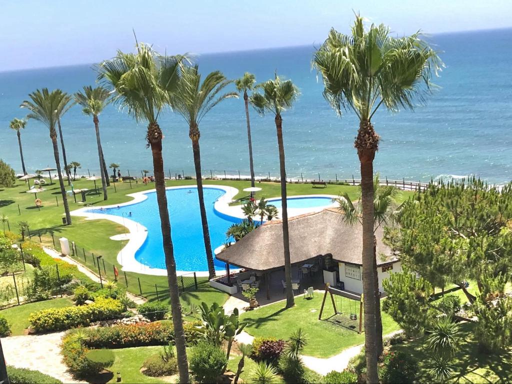 an aerial view of a resort with palm trees at Mi Capricho 2B1 Beachfront Complex-Apartment Beachside With sea views in Mijas Costa