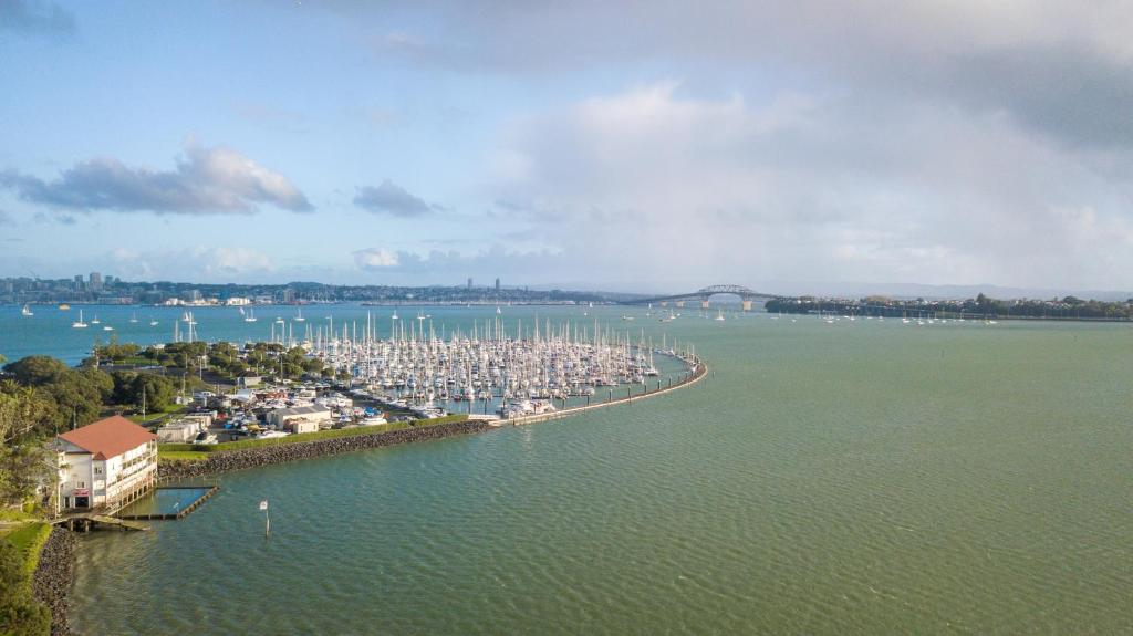 an aerial view of a marina with boats in the water at Ocean Breeze Hotel in Auckland