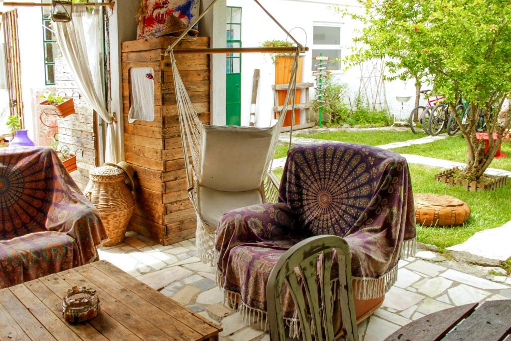 a patio with two chairs and a table at Natural Mystic Hostel in Costa da Caparica