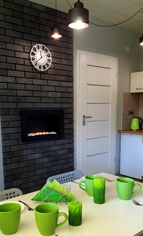 a kitchen with a table with green cups on it at Agro Relax Nowodwór 2 in Nowodwór