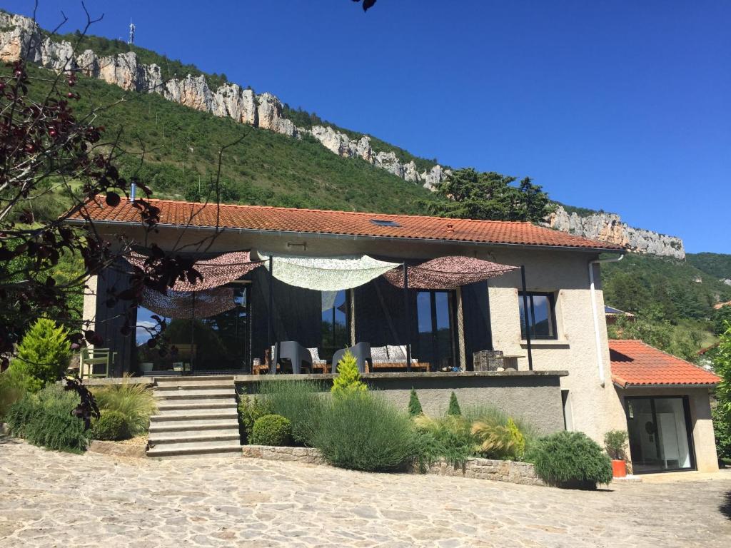 una casa con una montaña en el fondo en Dans la Pouncho d’Agast, en Millau