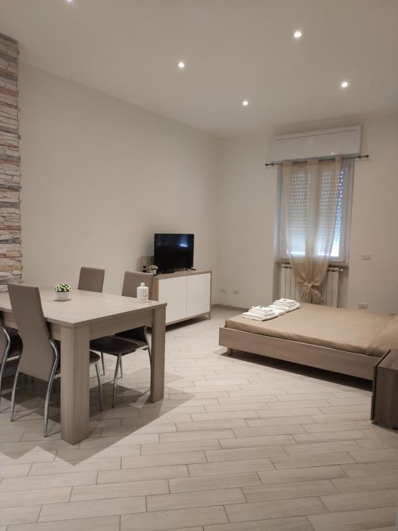 a bedroom with a bed and a table and chairs at Fiumicino Dream & Fly 2 in Fiumicino