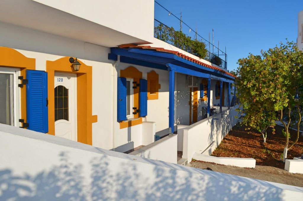 a row of houses with blue and yellow doors at Theofilos Appartements in Livadi