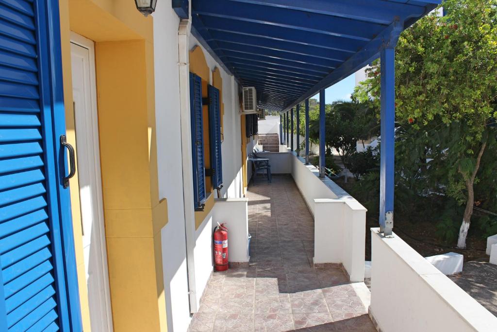 a hallway of a house with a blue roof at Theofilos Appartements in Livadi