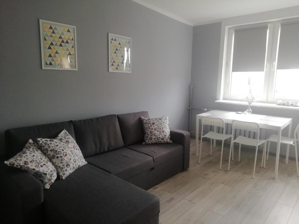 a living room with a couch and a table at Apartament Biała Mewa in Władysławowo