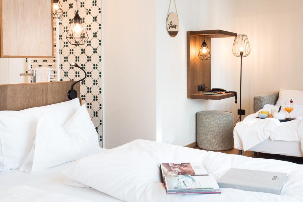 Postel nebo postele na pokoji v ubytování Hotel Tofana