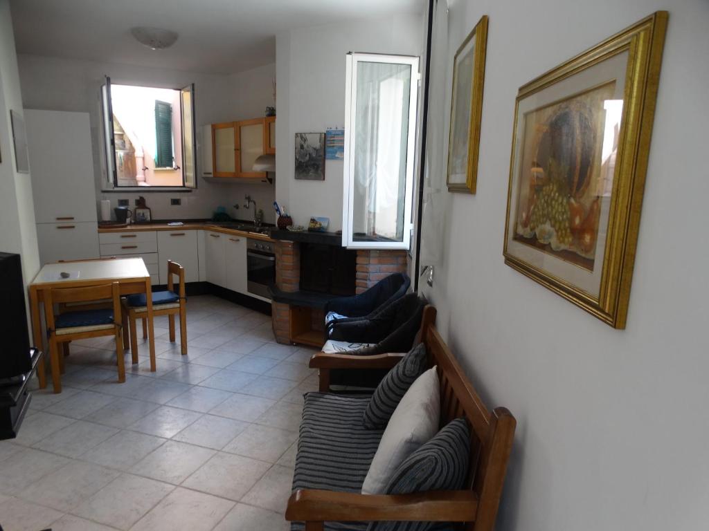 a living room with a couch and a kitchen at IRMA Manarola in Manarola