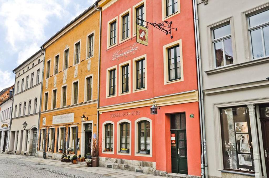 eine Reihe farbenfroher Gebäude auf einer Straße in der Unterkunft Altes Handelshaus Plauen in Plauen
