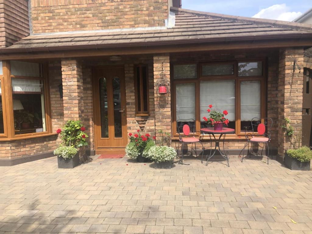 a brick house with a patio with a table and chairs at Beechtree House in Dublin
