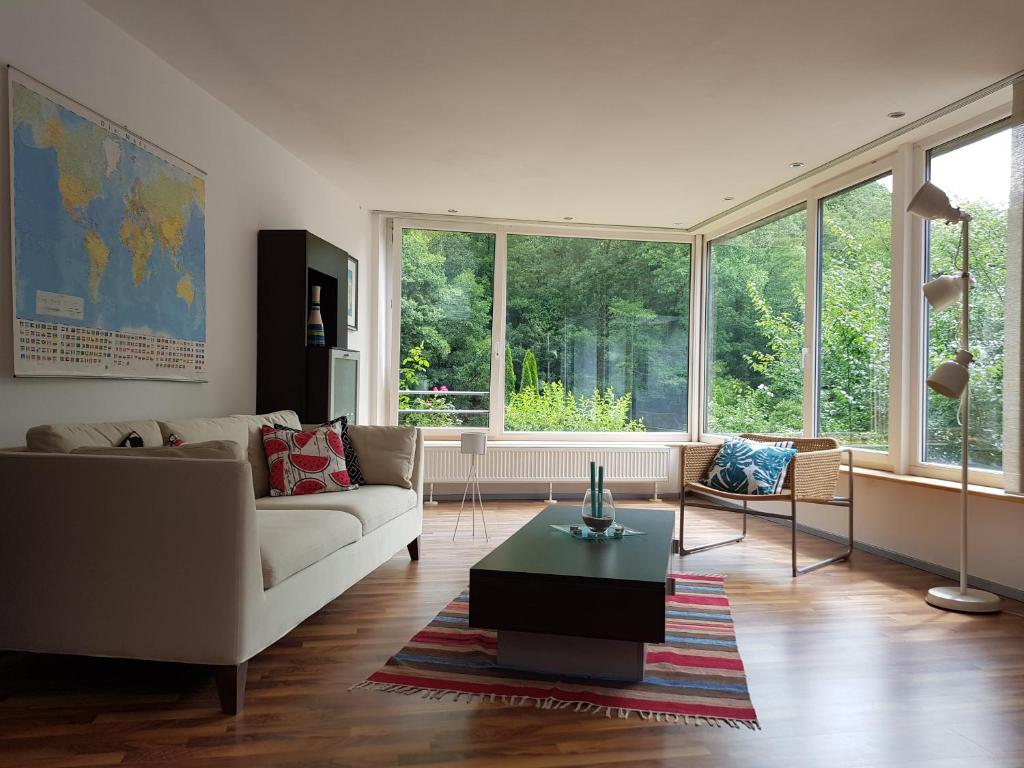 a living room with a couch and a table at Haus Waldblick in Nideggen