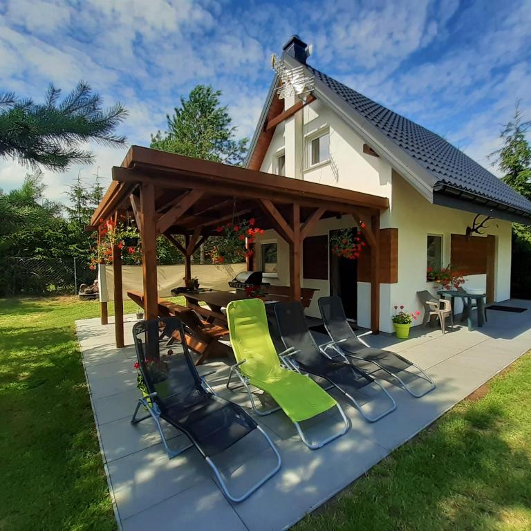 a patio with chairs and a gazebo at Letnia Ostoja Wieprz in Wieprz
