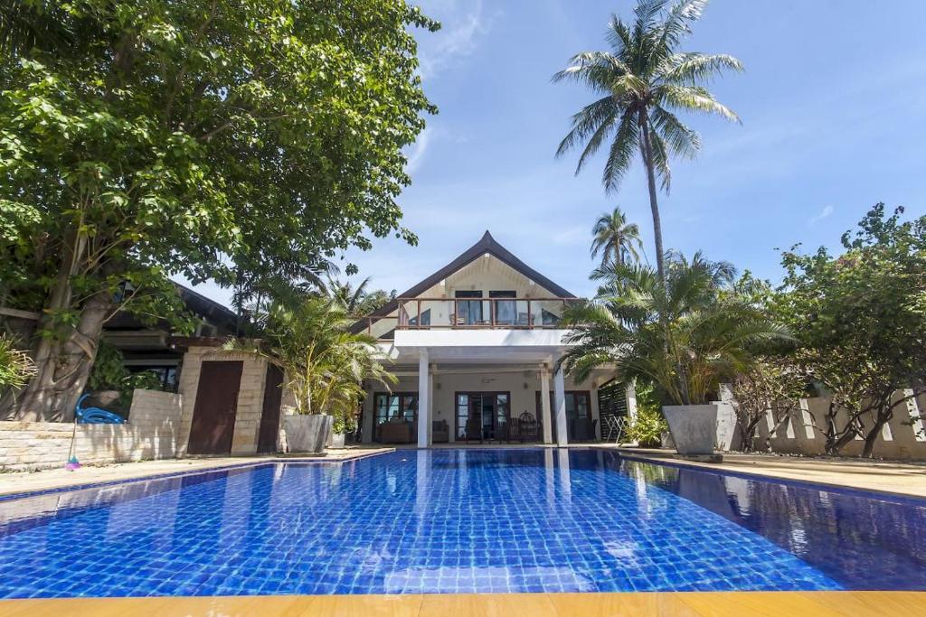 a swimming pool in front of a villa at Malee Beach A1 in Ko Lanta