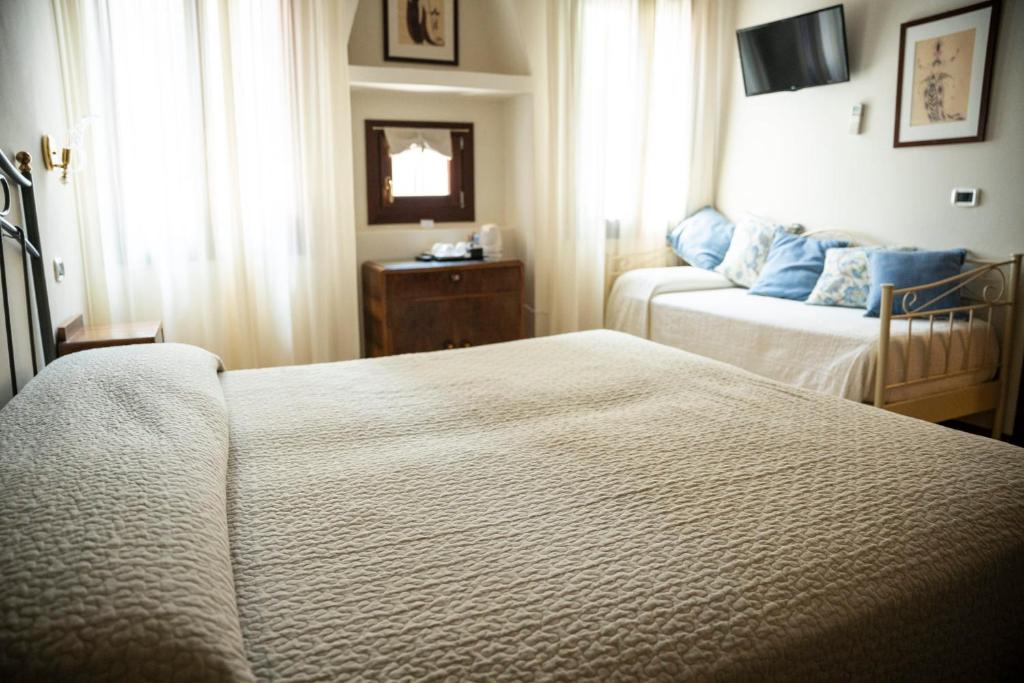 Postel nebo postele na pokoji v ubytování Locanda Art Deco