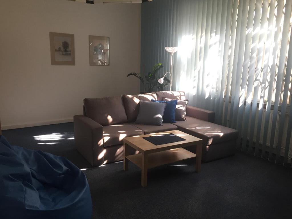 a living room with a couch and a coffee table at Blue apartment in beautiful English style garden with atmosphere in Prague
