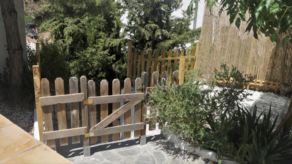 a wooden fence in front of a garden at Casa Cueva “La Estrella” in Granada