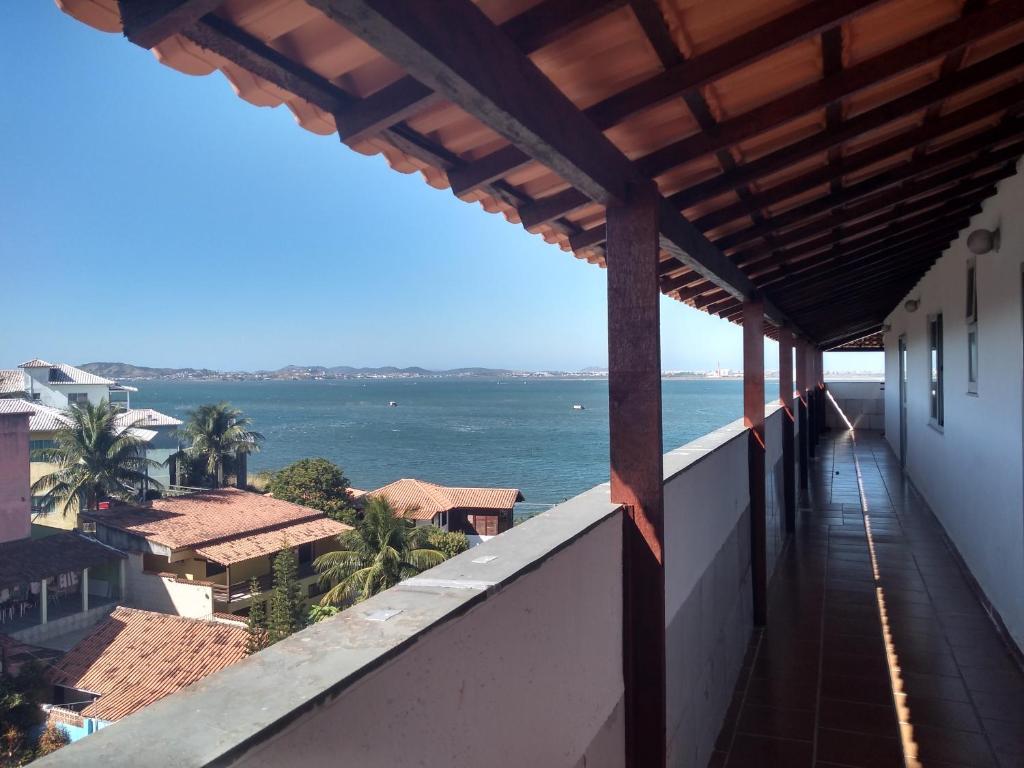 a balcony of a building with a view of the ocean at Apartamento Cobertura in São Pedro da Aldeia