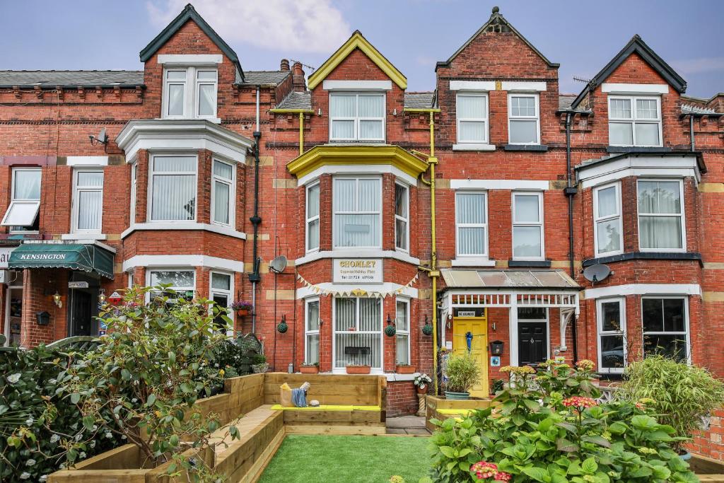 an apartment building with a garden in front of it at Chomley holiday flats in Scarborough