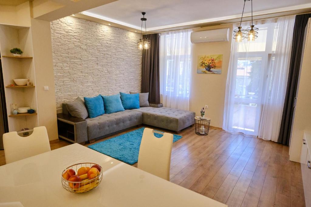 a living room with a couch and a table at Luxury Nevena Apartment - Bogoridi super centre in Burgas City