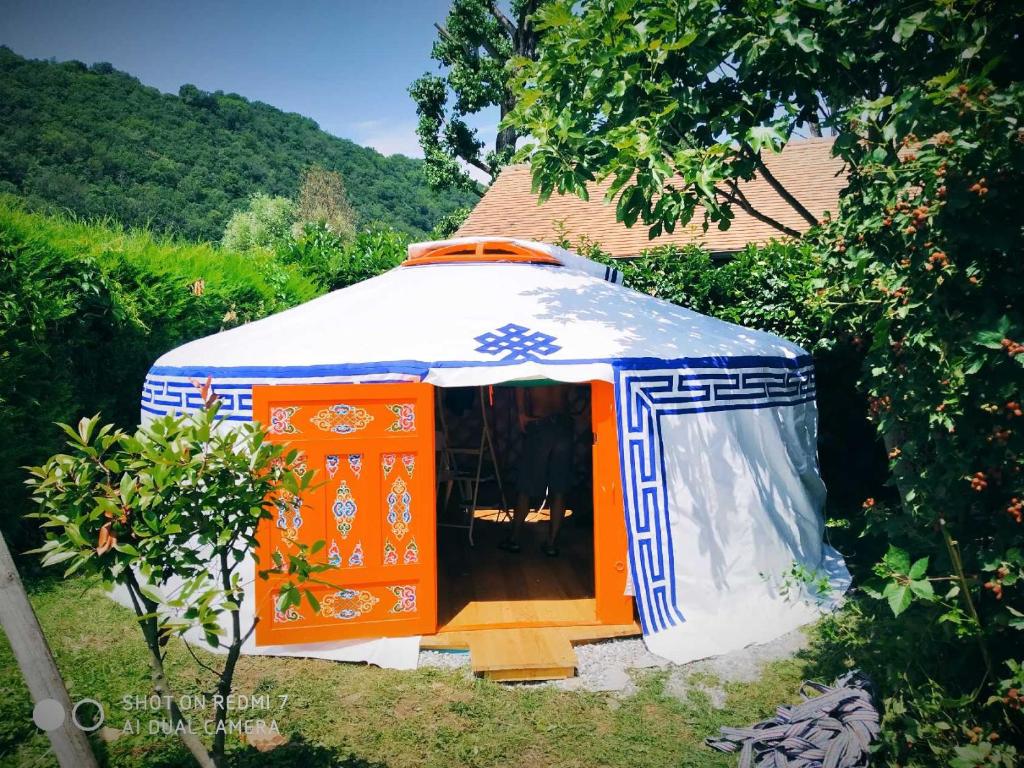 an orange and blue yurt in a yard at Eco Yourte Lac du Bourget in Conjux