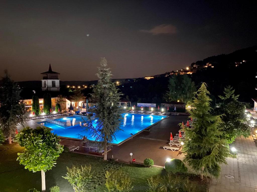 a large swimming pool at night with lights at Harmony Hills F35 Garden & Pool View in Rogachevo