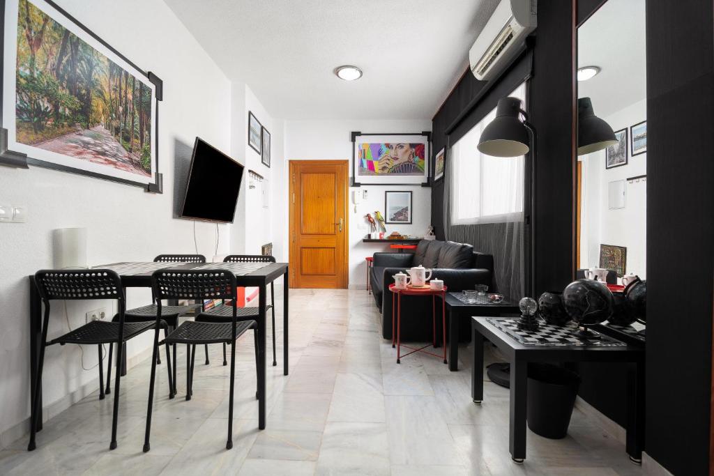 a living room with black chairs and a table at MZ flat in Málaga