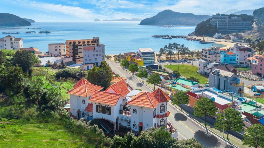 an aerial view of a town next to the ocean at Red Praha Pension in Geoje