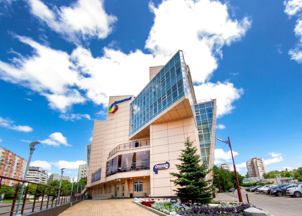 a building with a christmas tree in front of it at Hotel Olympic in Khabarovsk