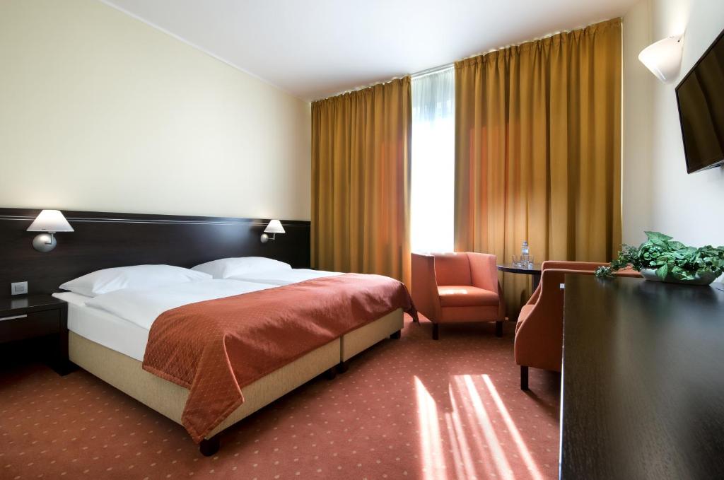 Postel nebo postele na pokoji v ubytování Hotel Tatra