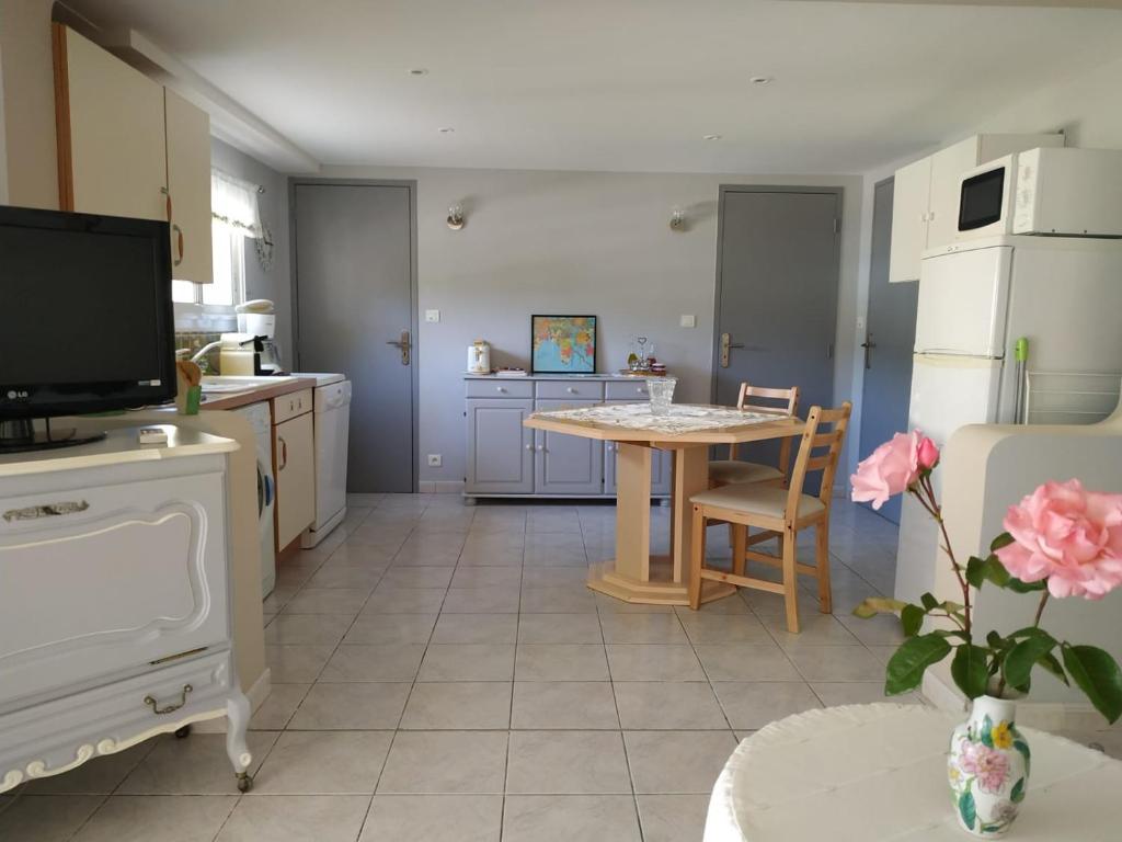 a kitchen with a table and a dining room at Villamijo in Le Beausset