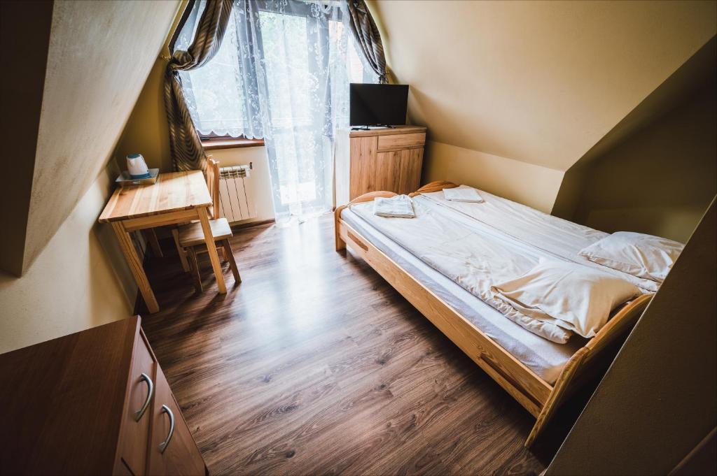 Posteľ alebo postele v izbe v ubytovaní Pokoje i Apartamenty Nad Potokiem