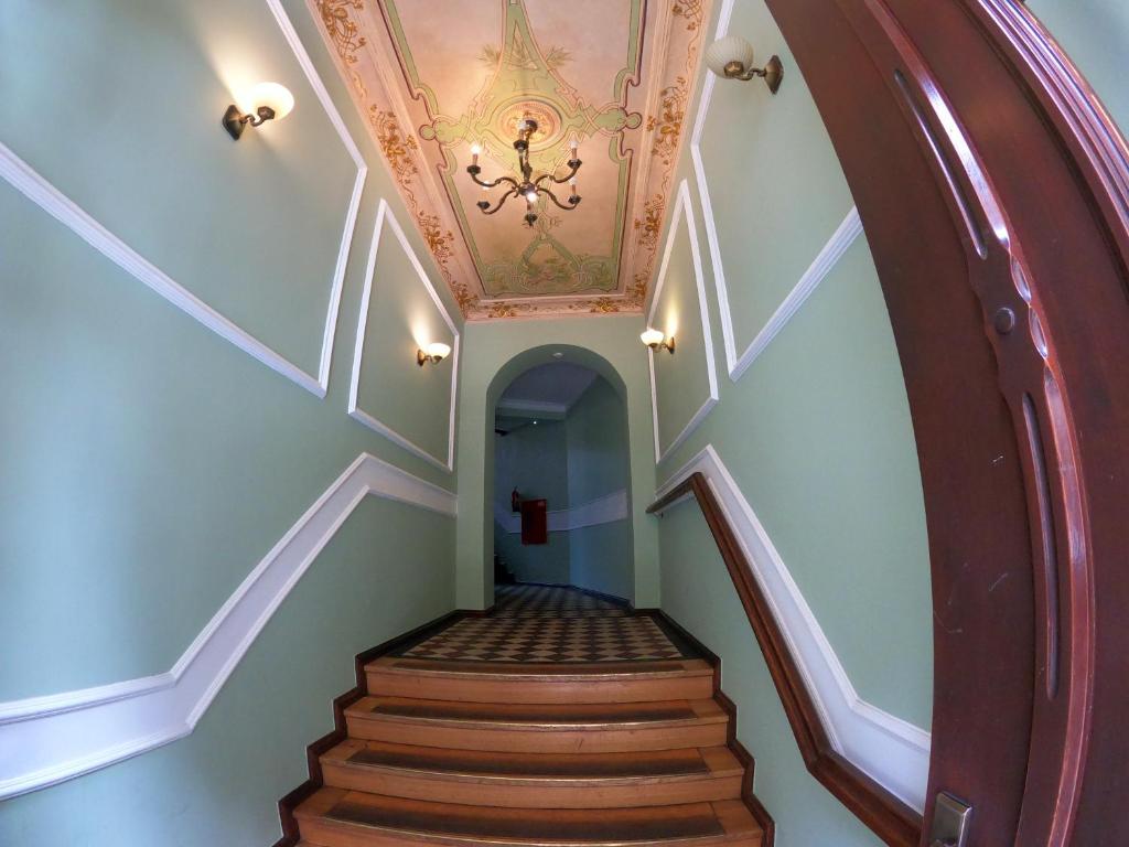 a hallway with a staircase with a ceiling at Apartamenty Apartlux in Poznań