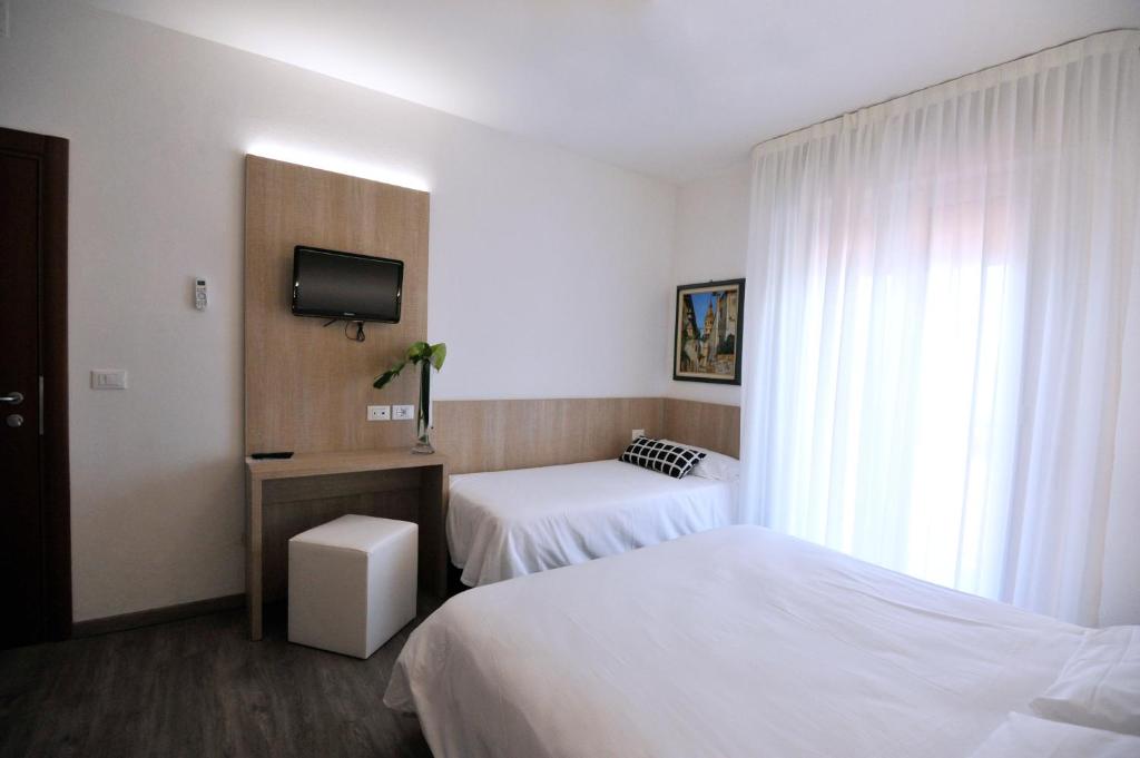 Postel nebo postele na pokoji v ubytování Hotel Etna