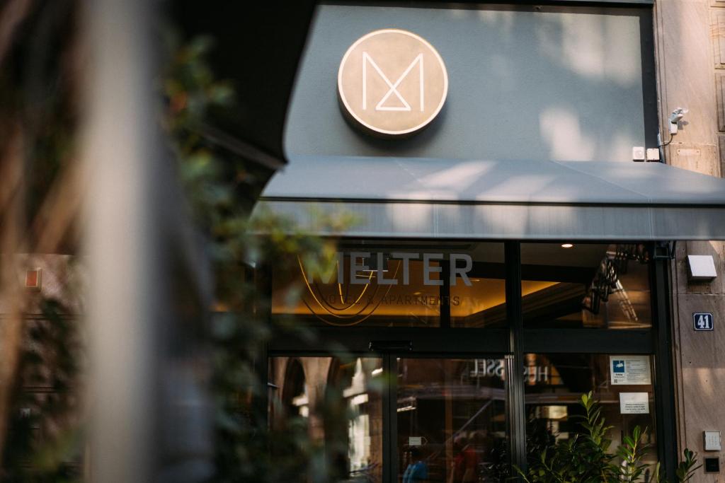 a sign on the front of a store at Melter Hotel & Apartments - a Neighborhood Hotel in Nürnberg