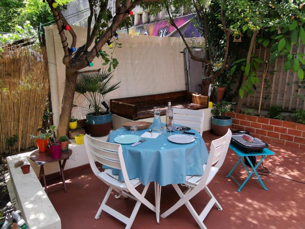 a table with a blue table cloth on a patio at Nice - Charming little house with terrace in Nice