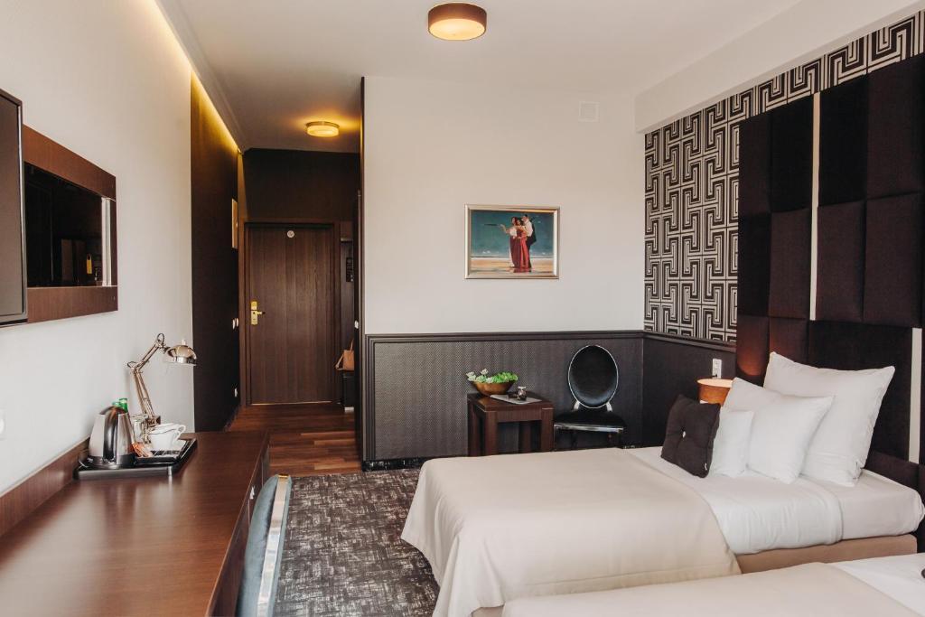 Posteľ alebo postele v izbe v ubytovaní Hotel Luxor