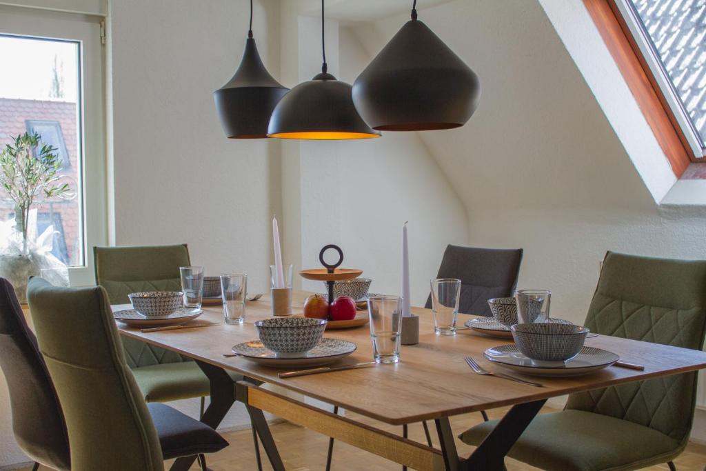 a dining room with a wooden table and chairs at Main Idyll in Frickenhausen