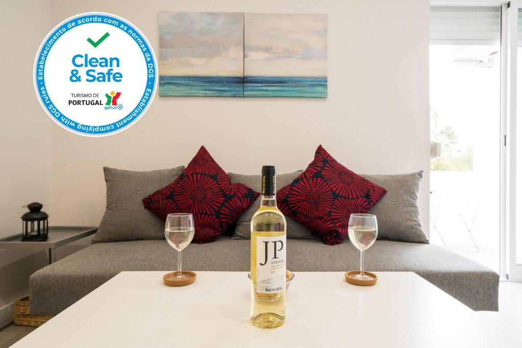a bottle of wine sitting on a table with two wine glasses at One Bedroom Seaview Urban Apartment Lagos in Lagos