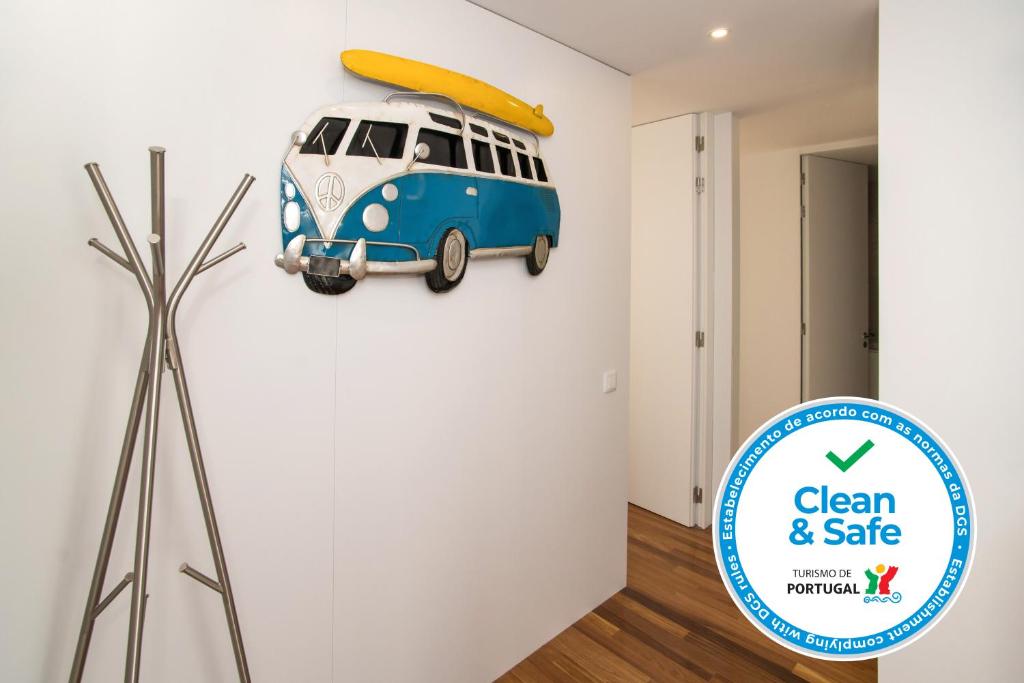 a wall art of a vw bus with a surfboard on it at Two Bedroom Stylish Central Tavira Apartment. in Tavira