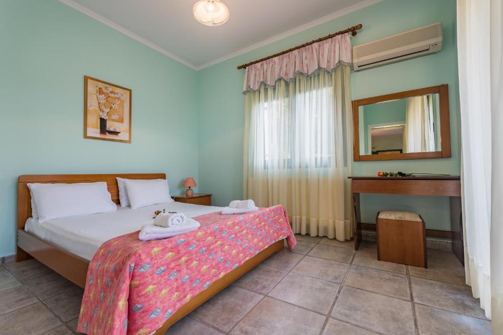 una camera con letto con specchio e scrivania di Small Village Residences ad Akrotiri