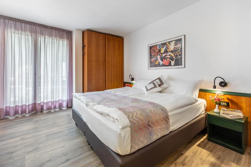 Postel nebo postele na pokoji v ubytování Pippo Hotel
