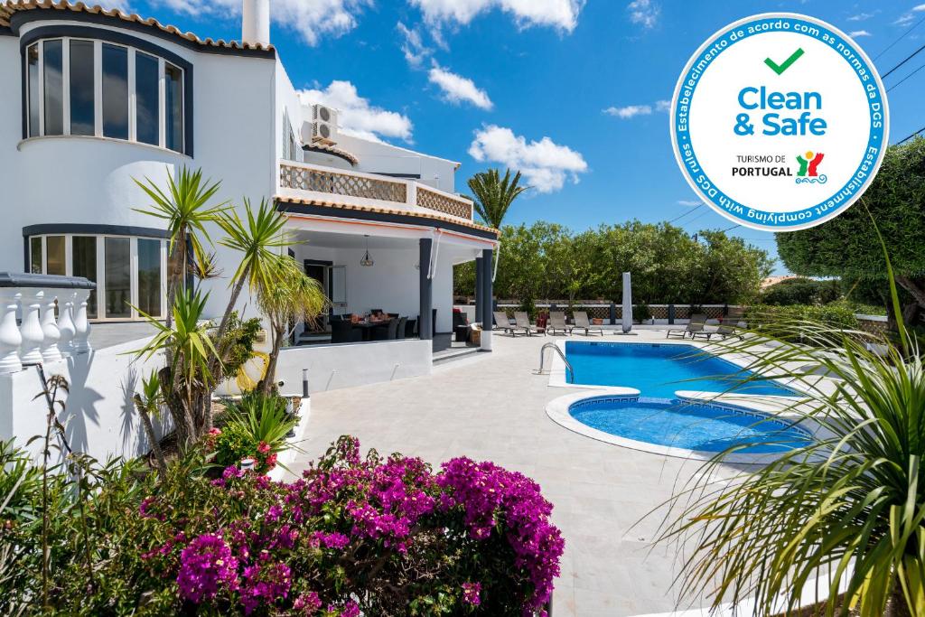 a villa with a pool and a sign that says clean safe at Casa Laranja Three bedroom Villa in Loulé