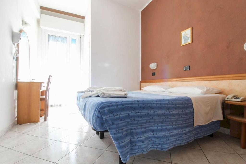 Postel nebo postele na pokoji v ubytování Hotel Abbondanza